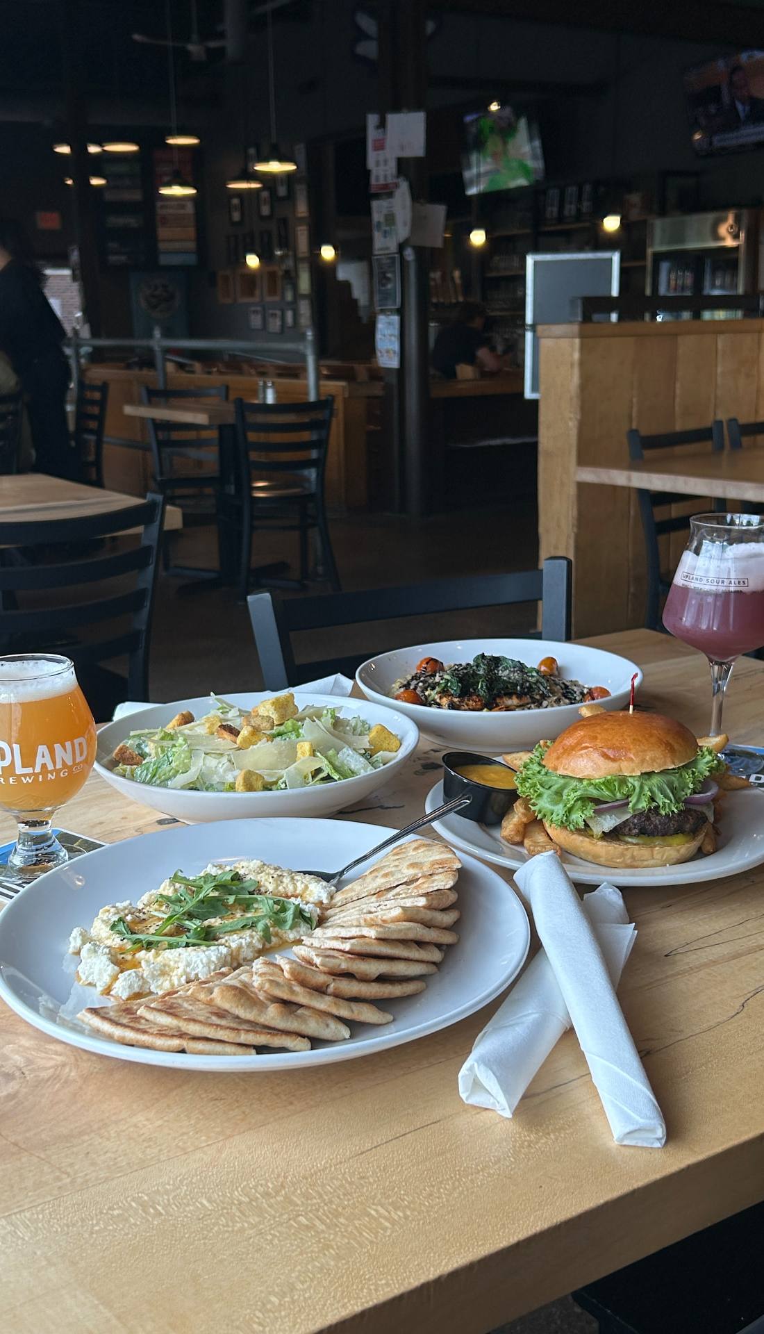 A table spread of Upland food and beer